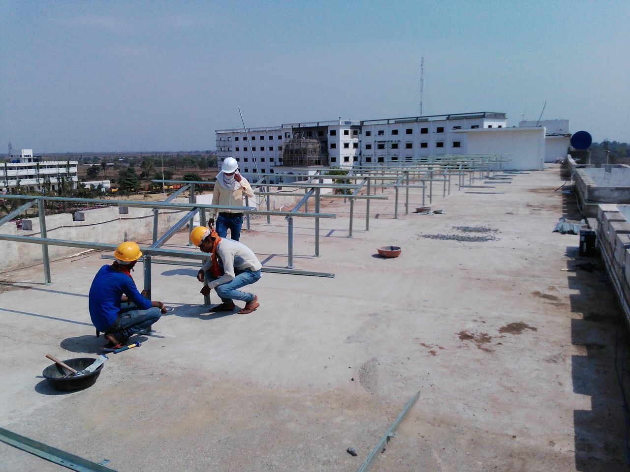 Engineers commissioning a completed rooftop plant.