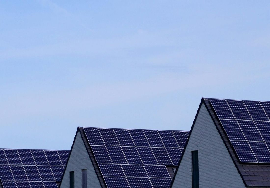 Solar panels installed across the sloping roof of a house.